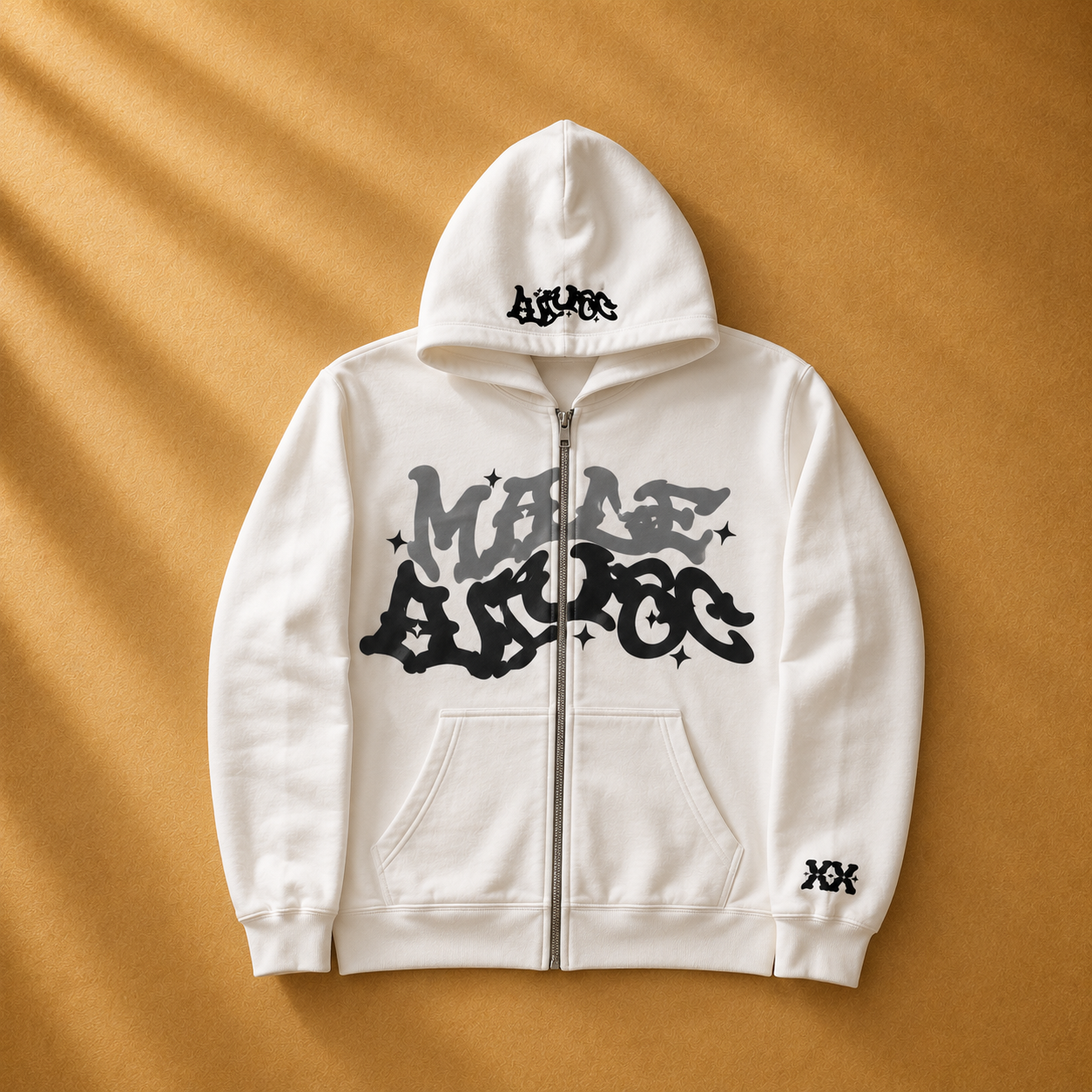 White hoodie with black text and graphics on a beige background