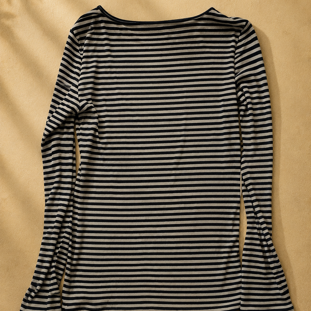 Black and white striped long-sleeve top on a beige background