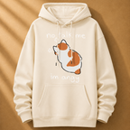 Beige hoodie with a cartoon cat and text on a brown background